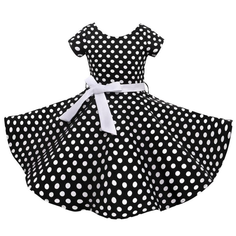 Robe enfant inspirée des années 70, style vintage chic avec motifs colorés et coupe rétro, idéale pour les occasions spéciales.